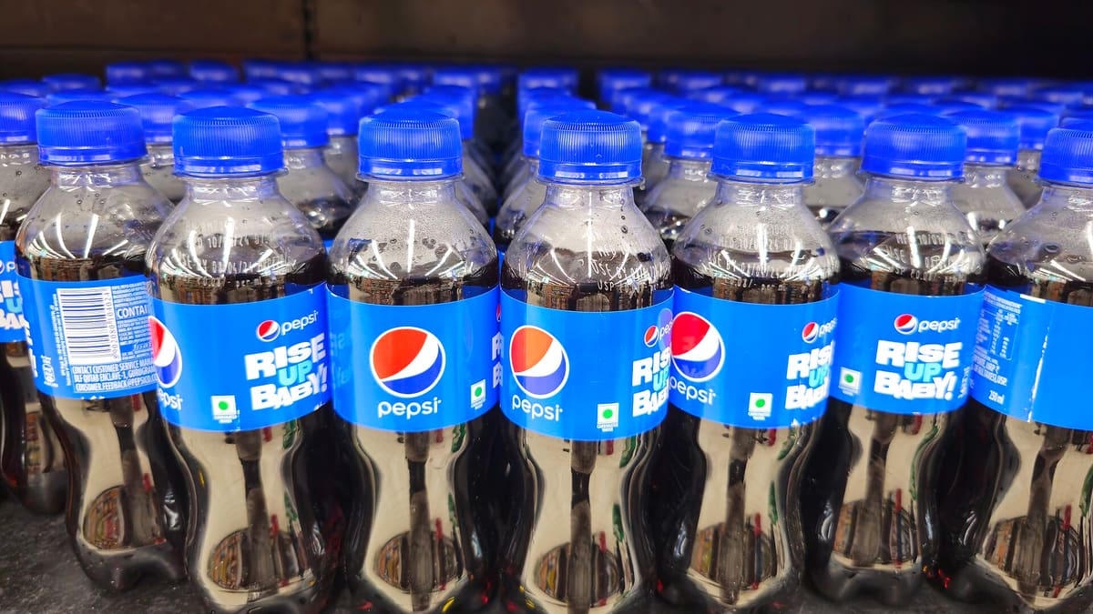Rows of 200 ml Pepsi bottles on a store shelf