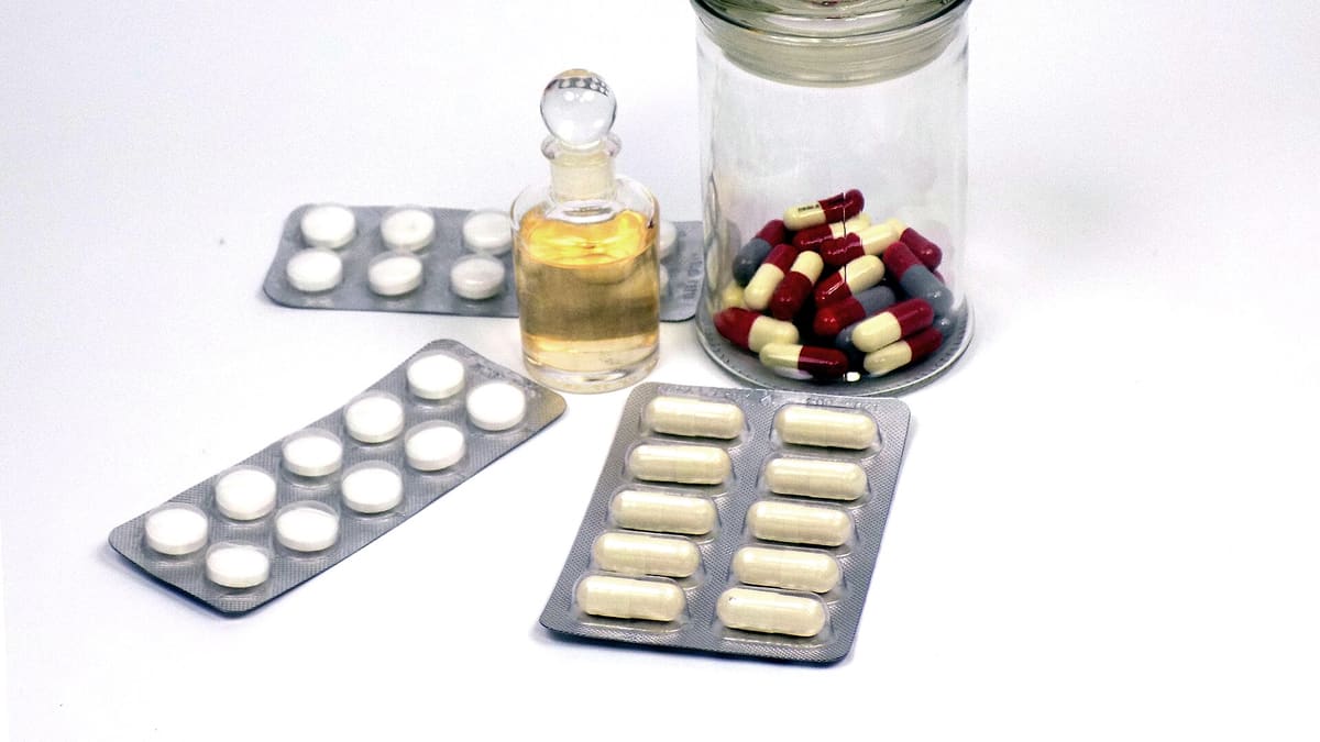Tablets and capsules in blister packs and a glass jar